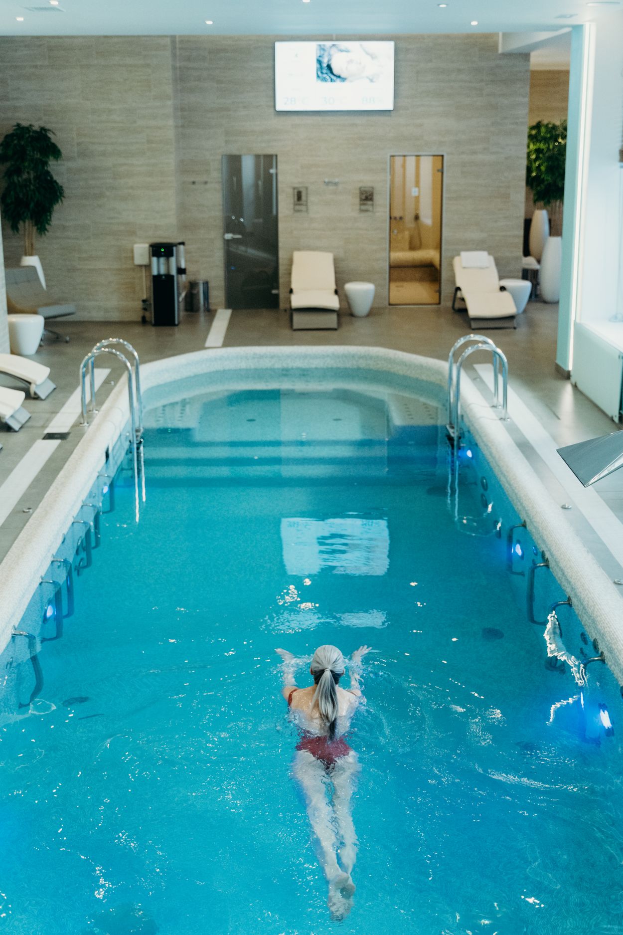 Indoor spa pool with blue water (editorial stock photography)