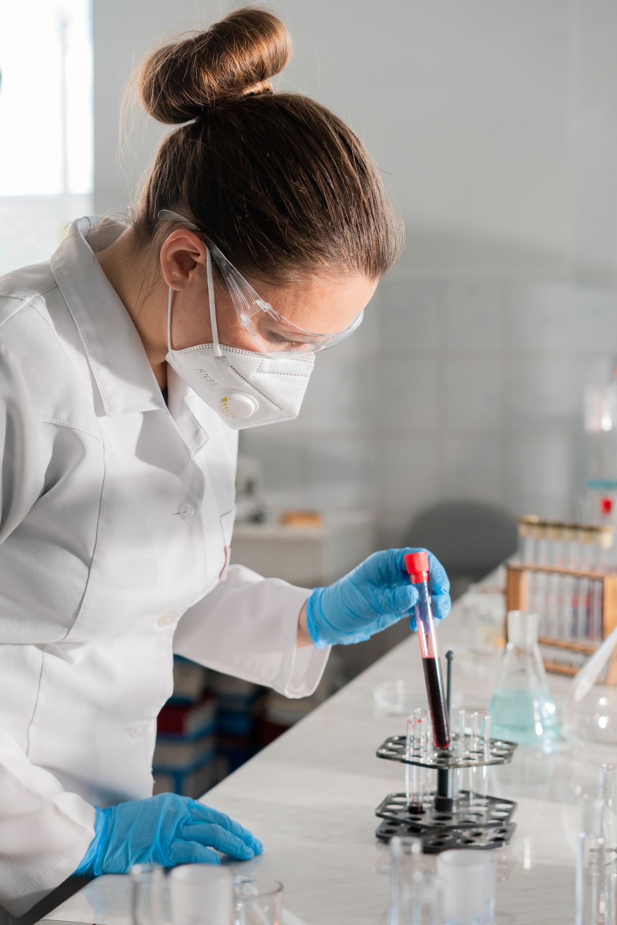 Laboratory professional analysing a medical sample (editorial stock photography)