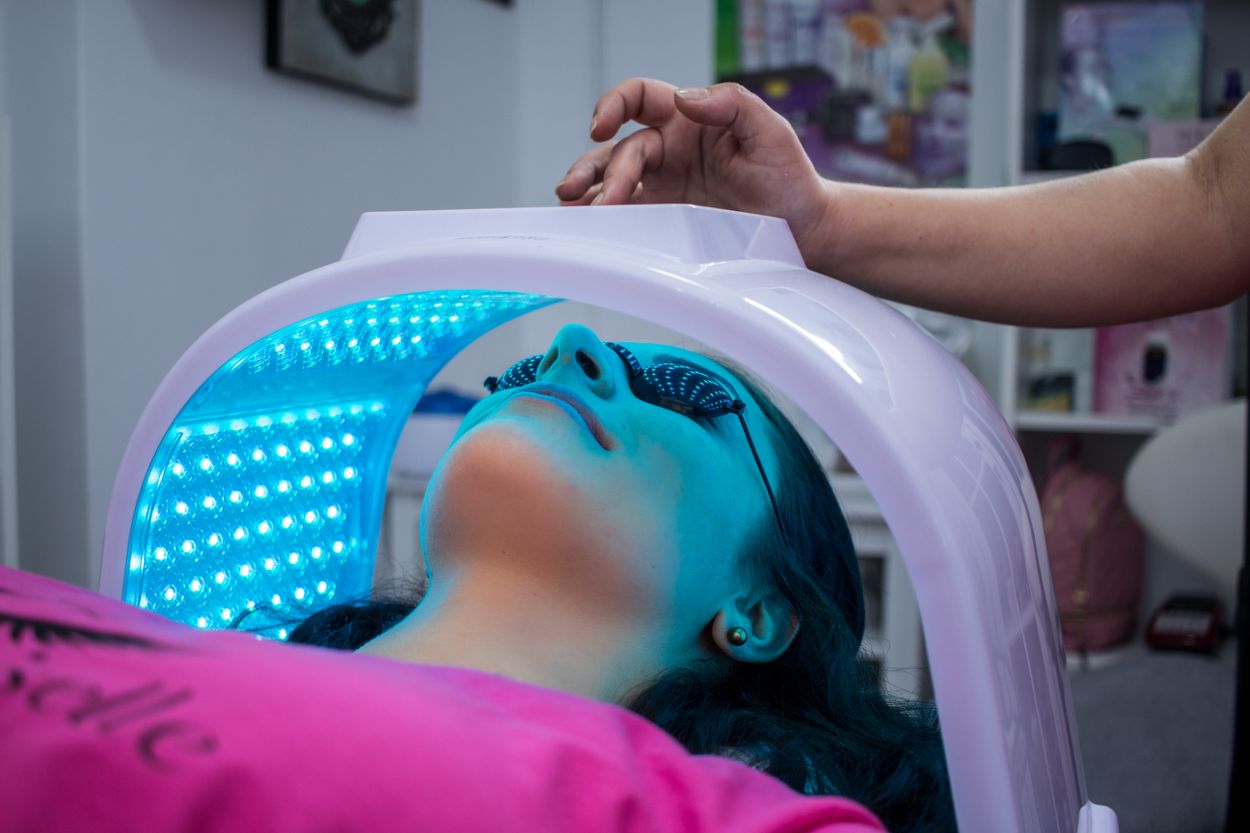 Person receiving a light-based spa treatment (editorial stock photography)