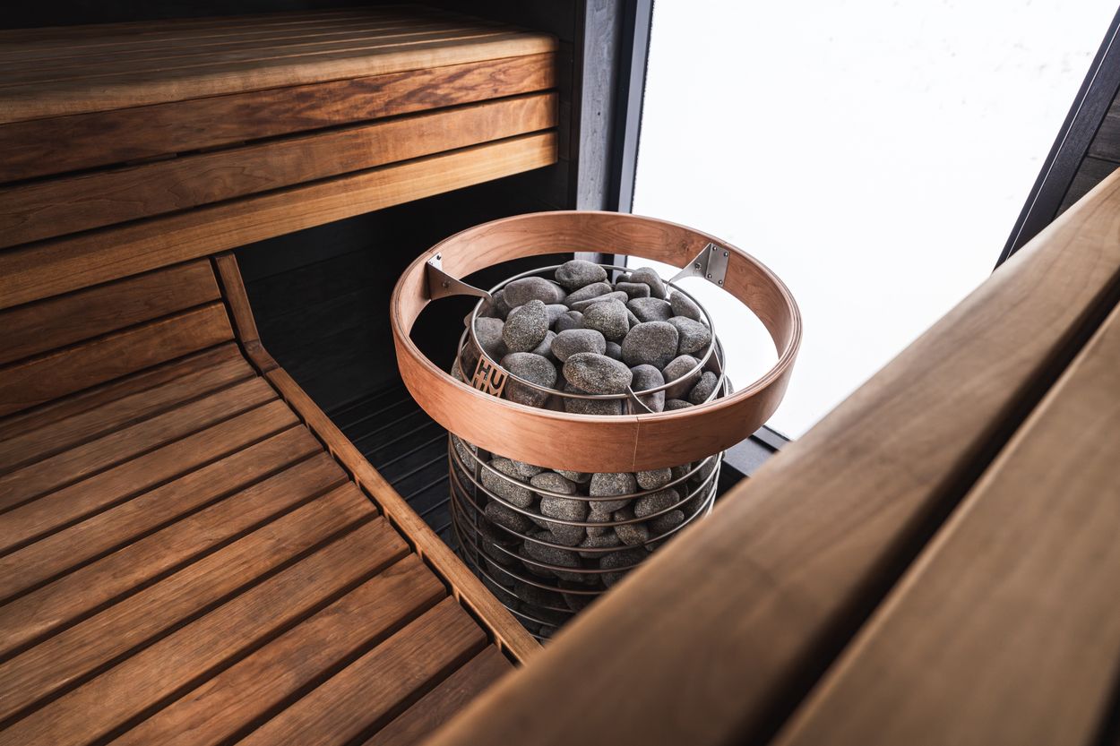 Traditional sauna heater and wooden interior (editorial stock photography)